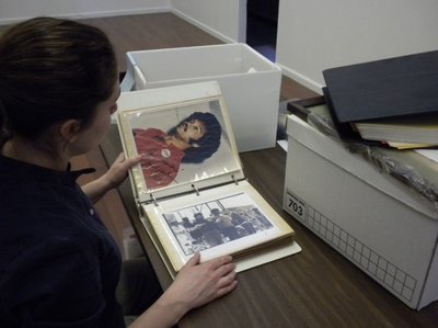 A woman looks at a photo album