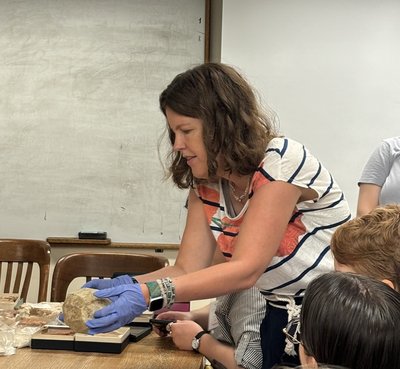 Professor holding clay tablet