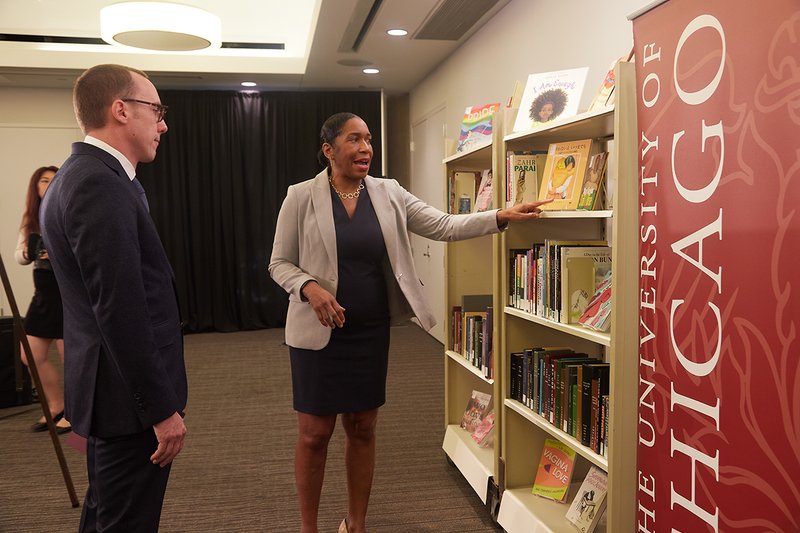 Lt. Gov. Stratton speaks to Dean Reimer while pointing to banned books on display