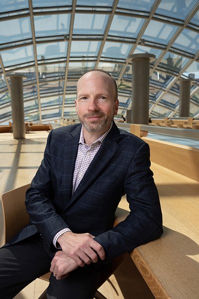 Thomas Dannenberg sitting in Mansueto Library under the glass dome