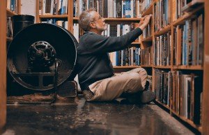 Co-op General Manager Jack Cella squeezes in next to old mechanical bellows, long since defunct but of perpetual interest to customers.